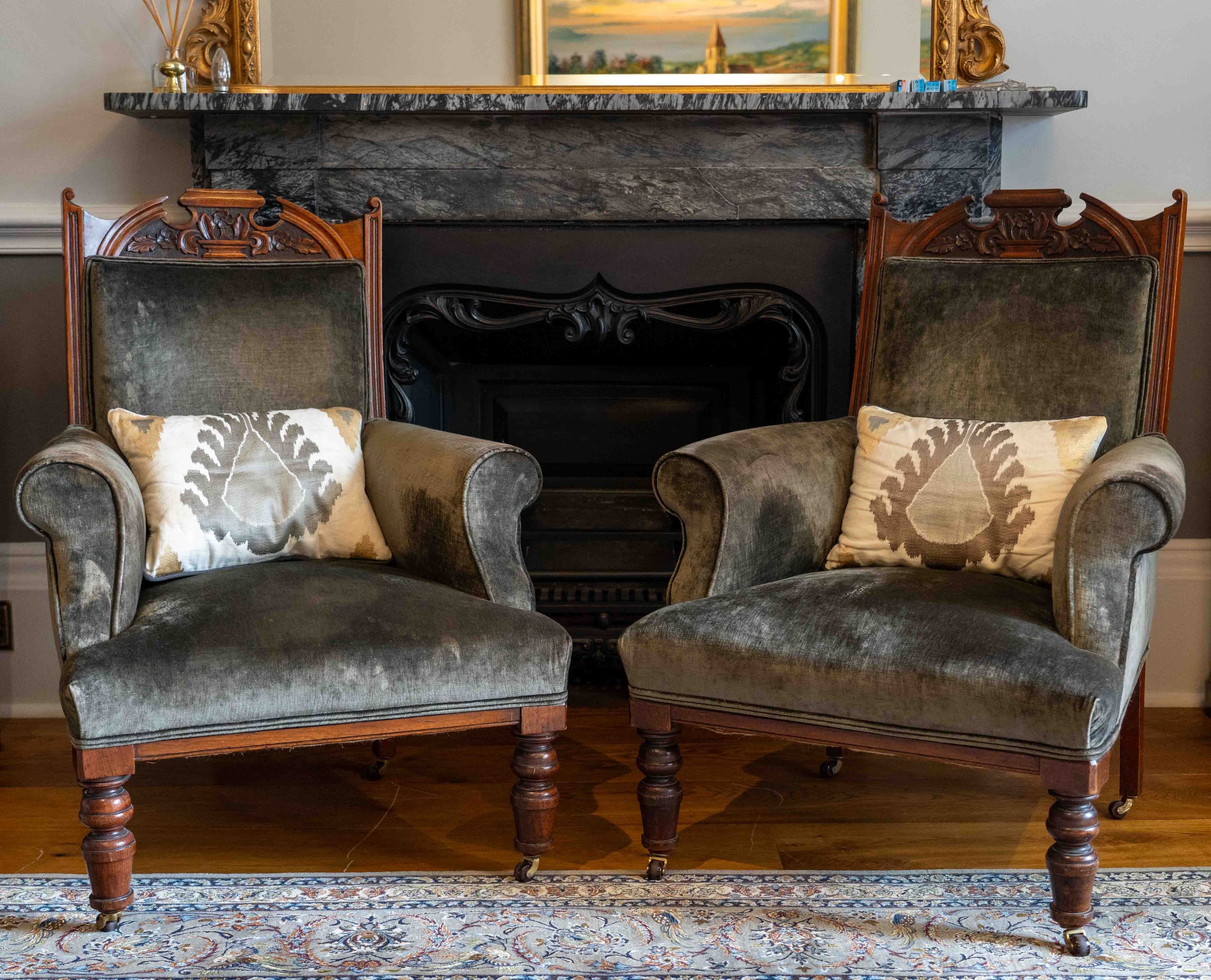 A pair of late Victorian upholstered walnut armchairs, width 73cm, depth 68cm, height 98cm. Condition - fair